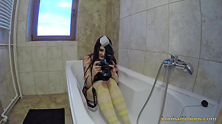 Redhead with her pantyhose and converse into the bath tub