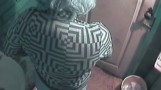 Mature white lady with blue dyed hair filmed in the toilet room