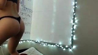 In a kitchen a sexy brunette playing with her big boobs