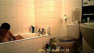 Brunette uses the toilet and takes a shower