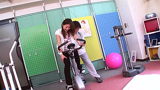 Hot asian girl shown how to ride a bike