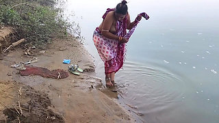 Indian village wife bathing in the river in outdoor area