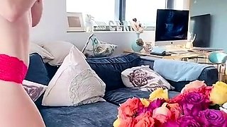 Beautiful busty MILF in red panties plucking rose petals