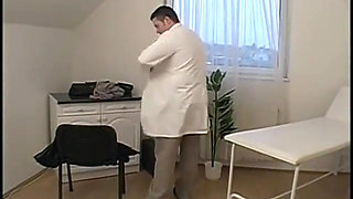 Girl in ponytails kneels to suck off a surgical masked doctor
