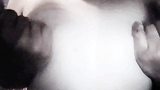 A girl roughly fondles her large breasts