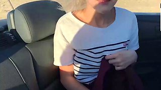 Blonde young adult with enormous tits in a car